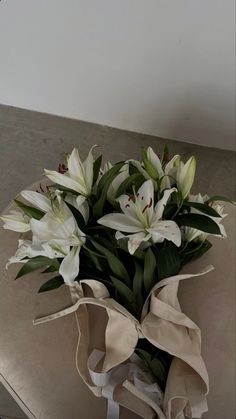 a bouquet of white flowers sitting on top of a table