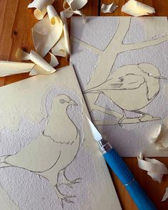 two birds are drawn on paper with a blue marker