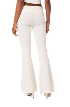 A fold-over ribbed waistband creates the low-rise silhouette of these perfectly flared knit pants. 100% acrylic Hand wash, dry flat Imported White Flared Leggings, Fold Over Pants, Knit Flare Pants, White Flare Pants, Babe T Shirt, Denim Corset Top, White Flares, Micro Skirt, Denim Corset