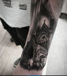 a man's arm with a black and white photo of a church on it