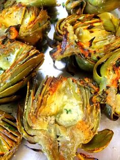 some artichokes are sitting on a white plate and ready to be eaten