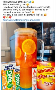 an orange drink in a blender surrounded by other drinks