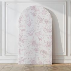 an arch in the corner of a room with pink wallpaper and wood flooring