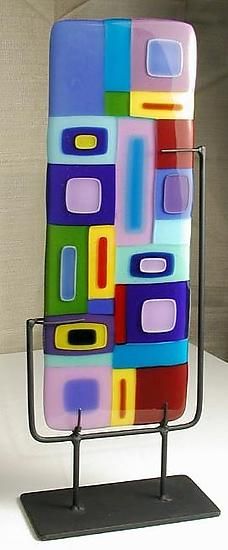 a multicolored cell phone is displayed on a stand