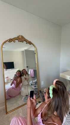 a woman sitting on the floor in front of a mirror