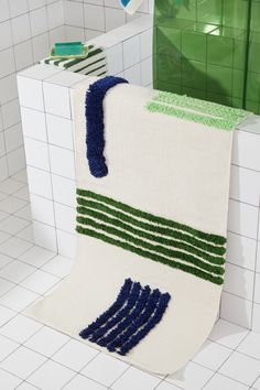 a white toilet covered in blue and green rugs