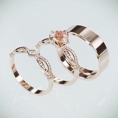 two wedding rings with pink and white diamonds on top of each other's shoulders