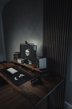 a computer monitor sitting on top of a wooden desk