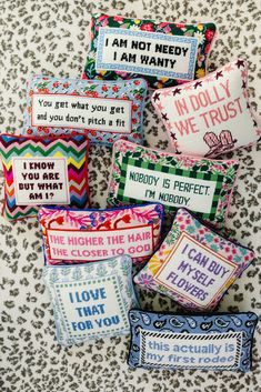 six pillows with different sayings on them