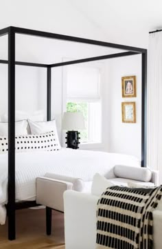 a white bedroom with black and white decor