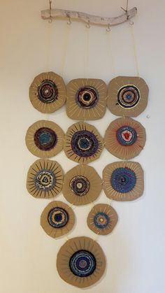 a wall hanging made out of paper plates and wood planks with an eyeball design