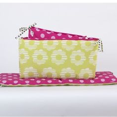 two pink and yellow bags sitting on top of each other with polka dot print fabric