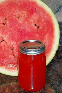 a watermelon slice and a jar of jam on a granite counter