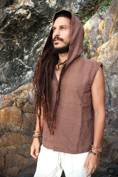 "Organic Plant Dyed Hooded Men Vest Comfy and casual Waistcoat/Vest made of hand loomed *khadi cotton and natural cotton lining. Wood buttons. Two outer pockets. You can find the Natural Khadi Cotton Pants here: https://www.etsy.com/uk/listing/1313710219/ SIZES S = 19 Inch Armpit to Armpit M = 20 \" \" \" L = 22 \" \" \" XL = 24 \" \" \" XXL= 26 \" \" \" COLOR Earthy Brown * Khadi is a traditional indian fabric made from handspun and handloomed cotton fibers. It is ethical guaranteeing the worke Brown Cotton Hoodie Top, Brown Cotton Hooded Top With Drawstring, Brown Cotton Top With Drawstring Hood, Brown Cotton Hooded Top, Brown Hooded Cotton Top, Brown Hooded Top With Drawstring, Outdoor Brown Hoodie With Adjustable Hood, Brown Cotton Hooded Jacket For Outdoor, Brown Cotton Hoodie For Outdoor