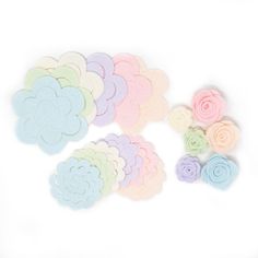 pastel felt flowers on white background with clippings to cut out the petals