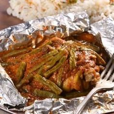 a close up of a plate of food with meat and green beans