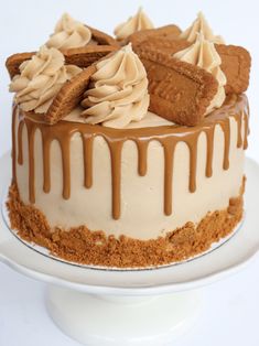 a close up of a cake on a plate with the words biscoff cookie butter cake