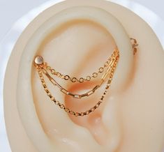 a pair of ear rings sitting on top of a white plate