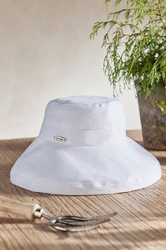 Handmade from lightweight and breathable cotton and branded with terrain exclusive details, this colorful crusher hat is perfect for a day at the beach or in the garden. Packable construction pairs with UPF 50 sun protection and an inner drawstring to assure a comfortable fit. | Cotton Crusher Hat in White at Terrain Cotton Bucket Hat With Short Brim For Travel, White Sun Hat, Cotton Sun Hat With Short Brim For Beach Season, Cotton Brimmed Bucket Hat For Travel, Casual Lightweight Packable Bucket Hat, Casual Cotton Bucket Hat For Travel, Adjustable Cotton Sun Hat For Summer, Cotton Sun Hat With Curved Brim For Beach Season, Adjustable Cotton Summer Sun Hat