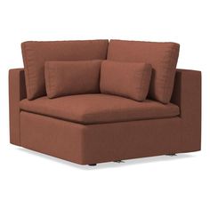 a brown couch with pillows sitting on it's backrest and the seat upholstered