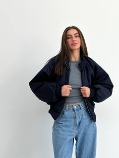 "Step into cold weather with an oversized navy blue women bomber jacket. Long sleeves and water repellent fabric finish - which encourages water to bead off its surface.  Plush poly fill adds extra warmth - 100% Recycled Polyester. Suitable for temperatures +10 С/-1 C ( 50.℉/30.20℉) More jackets here: https://www.etsy.com/shop/ArtVyshyvankaUA?ref=seller-platform-mcnav&section_id=39368873 🔷Model is 168cm/5'6\" and wearing size S. ------------------------------------------------------------------ Purple Bomberjack Outfit, Navy Blue Jacket Women, Navy Blue Jacket Outfit Casual Women, Navy Blue Jacket Outfit Women, Oversized Cropped Jacket For Streetwear, Navy Jacket Outfits For Women, Casual Navy Track Jacket, Trendy Navy Outerwear With Pockets, Navy Trendy Outerwear With Pockets