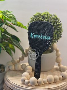 a wooden table topped with a potted plant and beaded tennis racquet