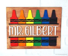 a wooden sign with crayons and the words mr albert on it