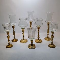 an assortment of glass vases sitting next to each other