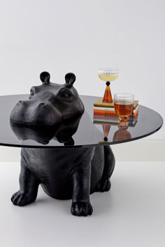 a glass table topped with a black rhino figurine