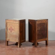 two wooden boxes sitting side by side on top of a tile floor next to each other