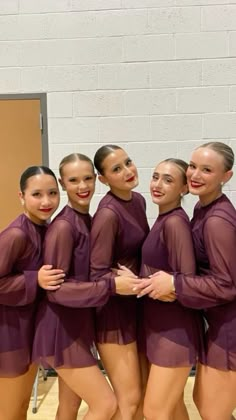 a group of young women standing next to each other