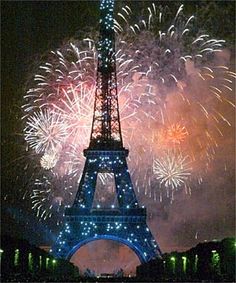 the eiffel tower is lit up with fireworks