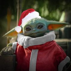 the child yoda is wearing a santa hat