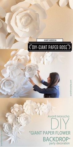 a woman is making paper flowers on the wall