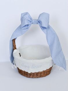 a blue and white basket with a bow on it