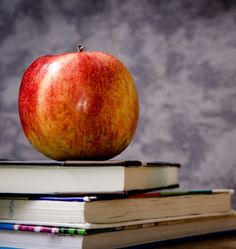 an apple sitting on top of two books