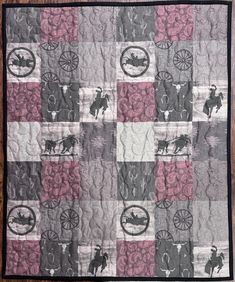 a quilt with horses and carriages on it