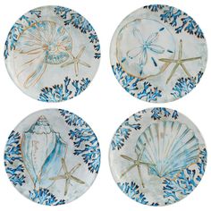 four plates with blue and white designs on them, each decorated with an image of a dragonfly