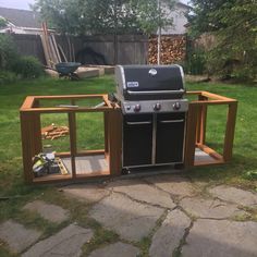 an outdoor bbq grill in the middle of a yard