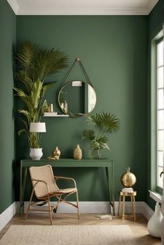 a living room with green walls and plants on the table in front of the mirror