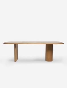 an oval wooden table with two legs and a long, slender top on a white background