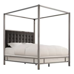 a white bed with a metal frame and headboard on it's side,