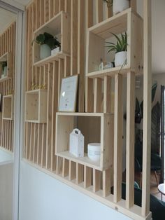 shelves made out of plywood are arranged on the wall