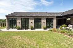 a brick house with glass doors and windows