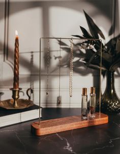 a table with candles, necklaces and other items on it in front of a mirror