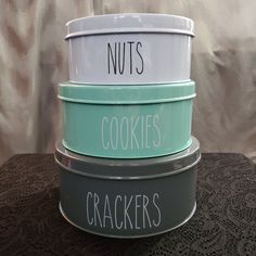 three bowls with the words nuts, cookies and crackers written on them