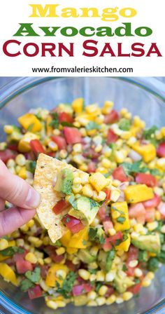 a hand holding a tortilla chip with corn salsa in it and the words mango avocado corn salsa