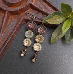 "Whimsical woodland earrings featuring flowers in several earthy colors - translucent purple, opaque sage green, off-white, and metallic bronze. A pretty look for summer and a great gift for someone who loves nature or rustic style. I finished the earrings with long antiqued brass plated ear wires - they are fairly lightweight. These pretty dangles would make a lovely gift for someone special or a sweet treat for yourself. Earring Length: about 3 1/4\" including the wire You can select lever bac Indie Earrings, Feather Earrings Silver, Boho Nature, Woodland Earrings, Whimsical Woodland, Lover Jewelry, Rustic Earrings, Boho Chic Earrings, Purple Quartz