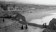 an old black and white photo of people on the beach