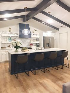 a kitchen with an island and bar stools